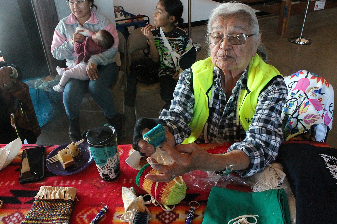 Grant PUD Cultural Resources Specialist and Wanapum Elder Ernestine Conner shows some examples of traditional weaving.