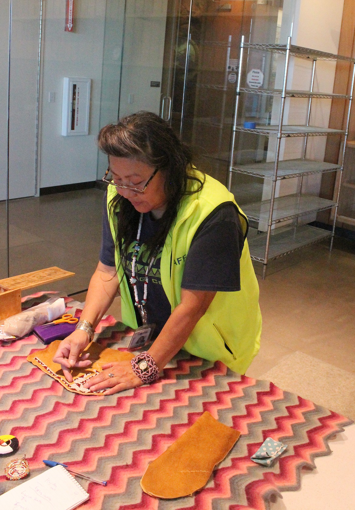 Grant PUD Cultural Project Worker Velma Wyena, a member of the Wanapum Tribe, shows how to make beaded moccasins from buckskin.