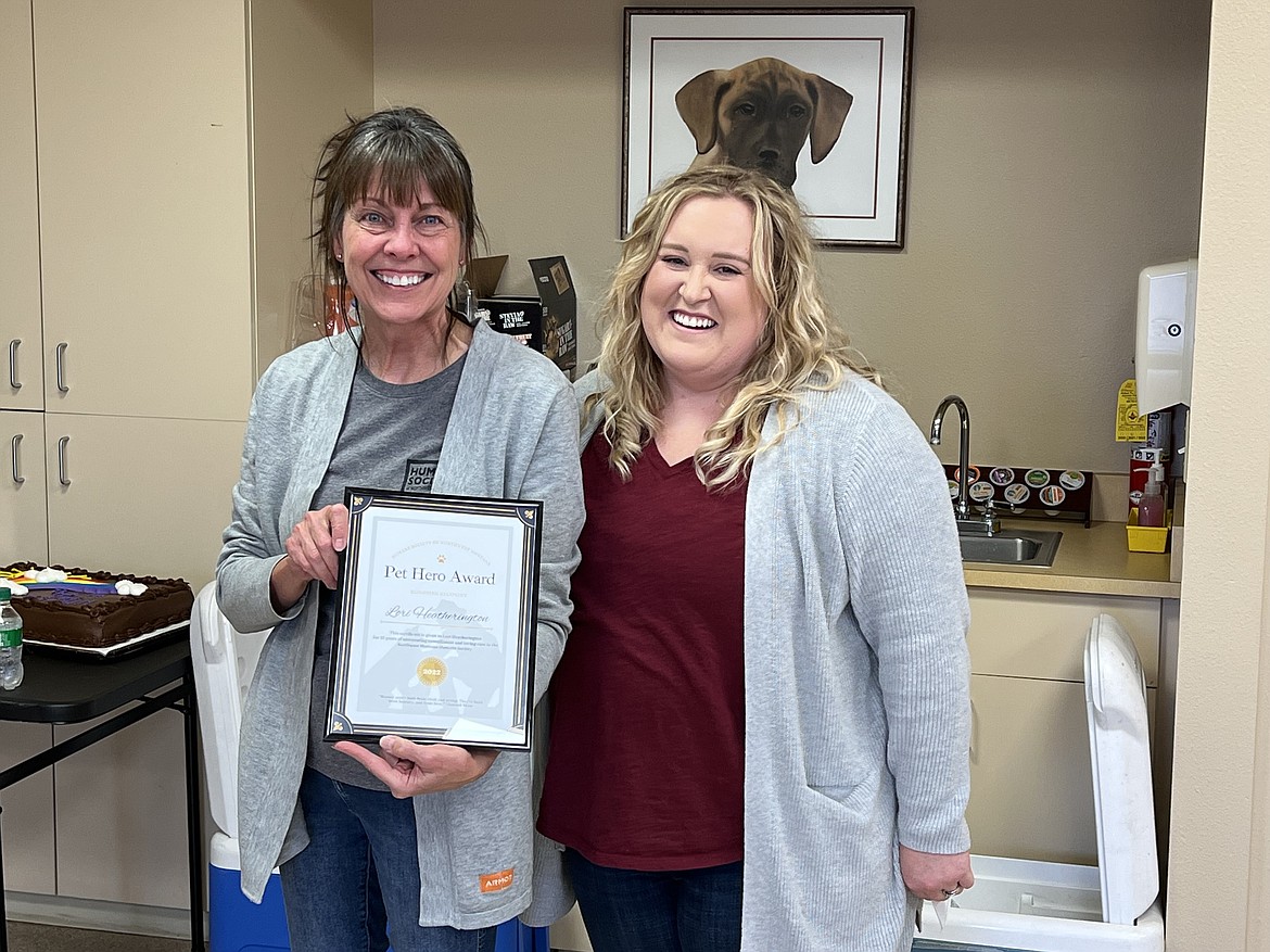 Lori Heatherington, pictured left, receives the Humane Society’s Pet Hero Award from Alanna Weibert, president of the board of the Humane Society of Northwest Montana.