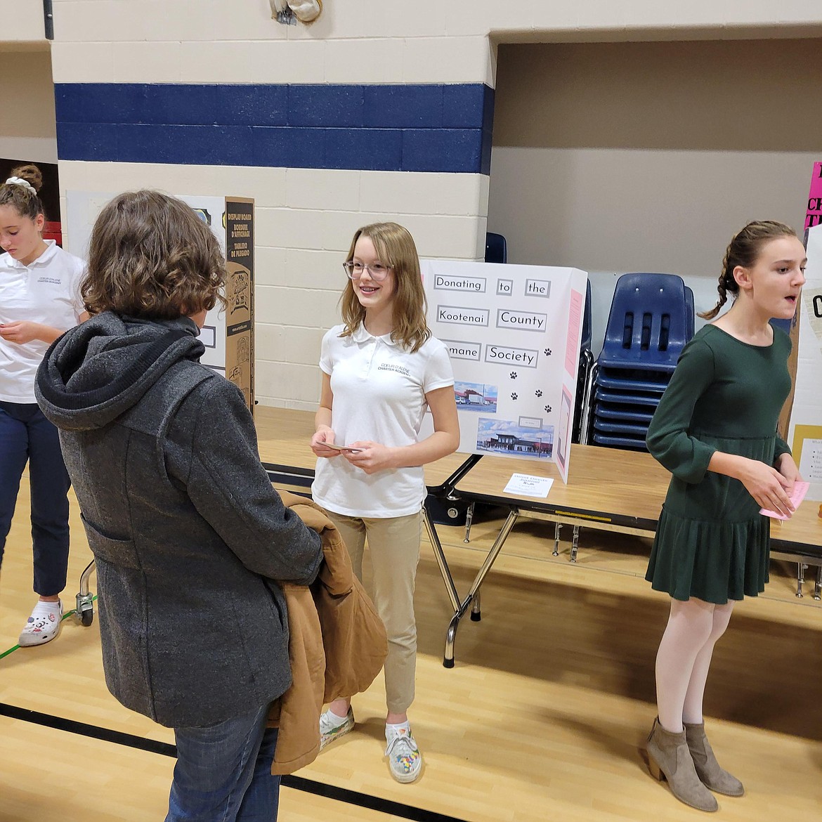 Coeur d'Alene Charter Academy sixth grader Grace Moore discusses how she raised money and collected supplies for the Kootenai Humane Society during a presentation night at the school earlier this week. The Good Deeds project concluded Friday with a walk through Forest Cemetery.