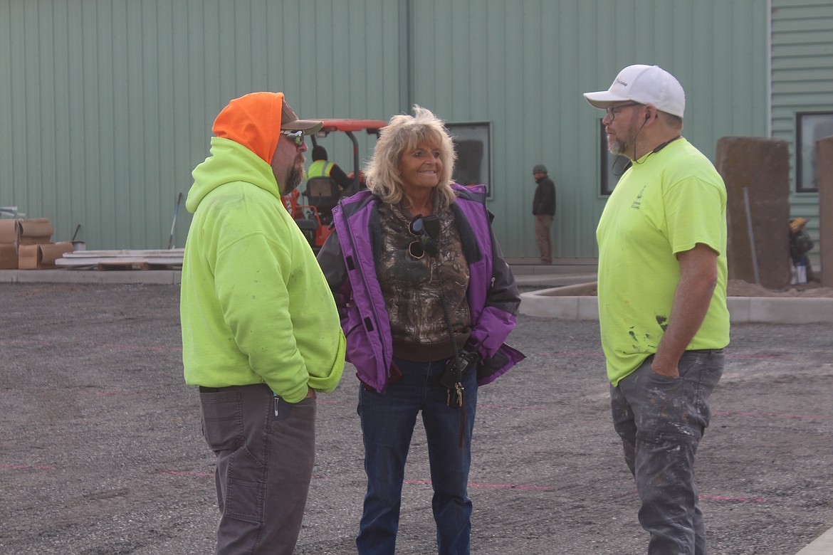 (From left) Contractor Matthew Ball, Moses Lake Food Bank Director Peny Archer and painting contractor Tom Simonson discuss ongoing work at the new food bank location Thursday.