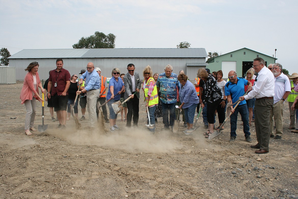 Dirt flies during the groundbreaking ceremony at the new Moses Lake Food Bank site in July 2021. The facility is scheduled to open in December
