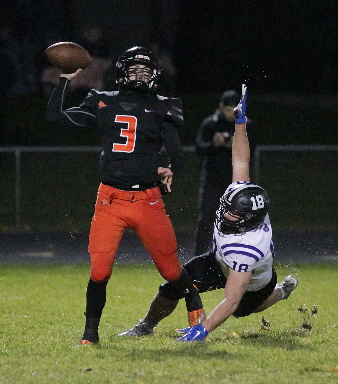 MARK NELKE/Press
Post Falls quarterback Isaac McKeown (3) throws under pressure from Parker Weatherly (18) of Rocky Mountain on Friday night in Post Falls.