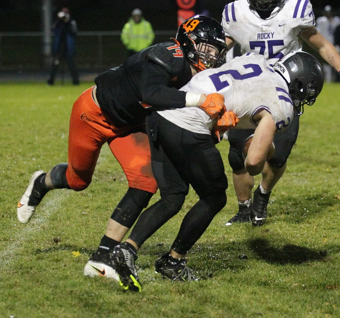 MARK NELKE/Press
Matthew Ludwig (19) of Post Falls tackles Art Williams of Rocky Mountain for a loss on Friday night in Post Falls.