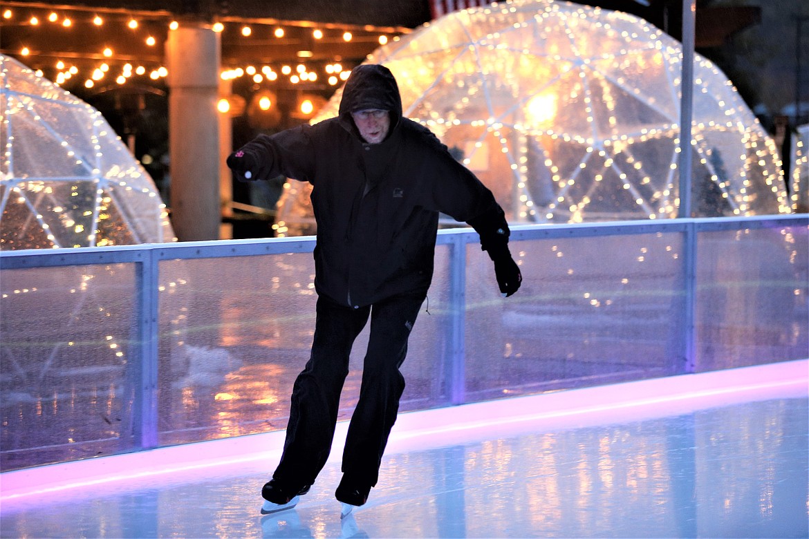 Tom Burke of Coeur d'Alene glides around the ice-skating rink, "Coeur d’Alene On Ice," at McEuen Park on opening day Friday. For the second year in a row, owners Andrea and Jerome Murray partnered with Numerica Credit Union to bring back Coeur d’Alene On Ice, which is scheduled to be open daily through January. Despite the rain, Tom Burke and wife Becky enjoyed their time on the ice.