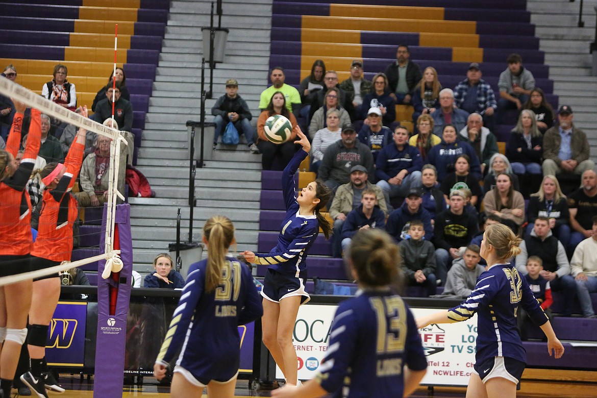 MLCA/CCS eighth grader Graycie Kast rises up to return a ball over the net in the first set against Entiat.