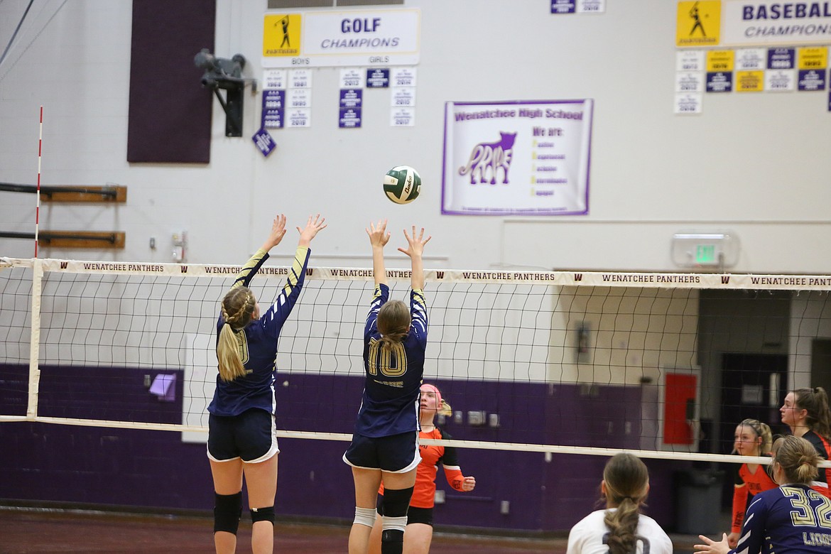 MLCA/CCS senior Kali Kast (left) and freshman Maria Gulenko go for a block against Entiat in Thursday’s district championship.