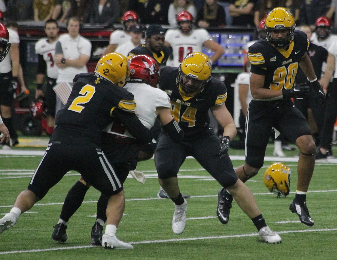 MARK NELKE/Press
Nate DeGraw (94) of Idaho, the former Post Falls High star, and teammate Fa'Avae Fa'Avae tackle Eastern Washington quarterback Gunner Talkington on Saturday in Moscow.