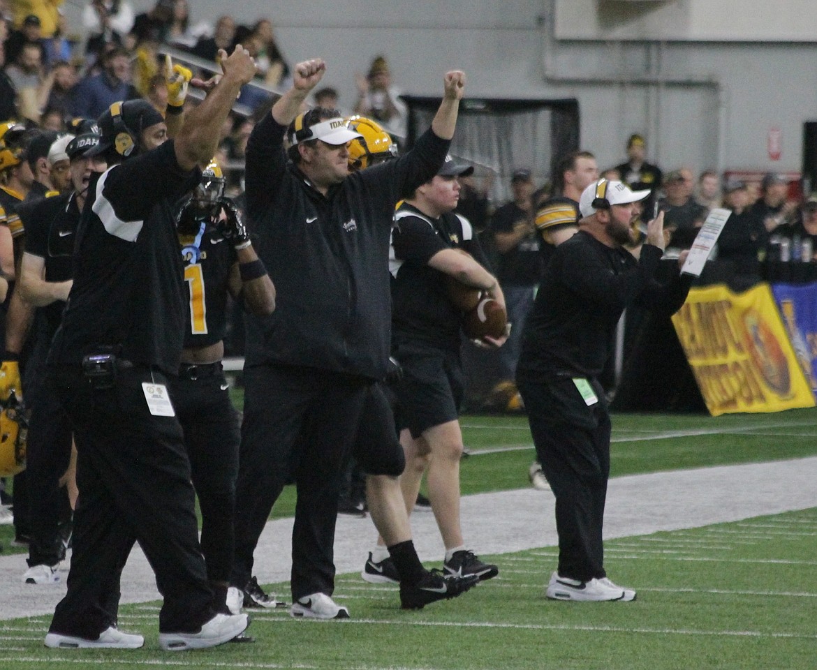 MARK NELKE/Press
Idaho coach Jason Eck, center, and some assistant coaches celebrate a defensive stop in the first half Saturday against Eastern Washington in Moscow.