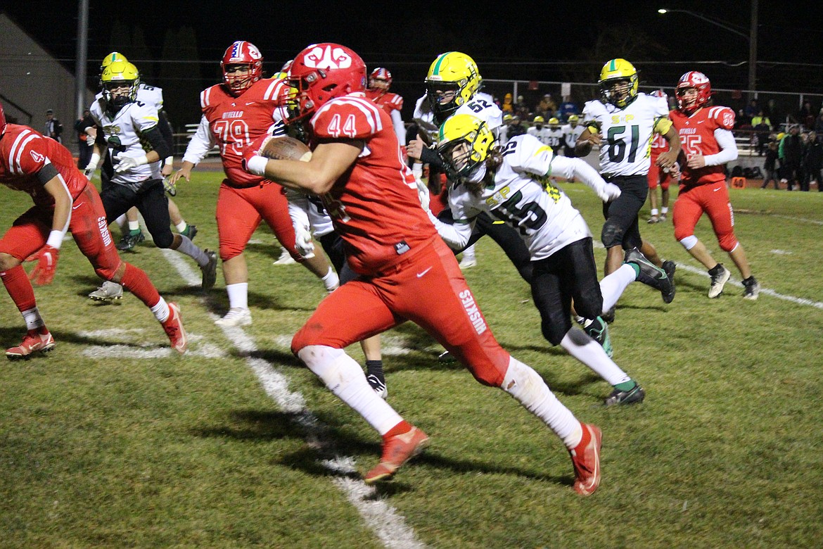 Julian Alegria (44) works his way upfield against the Shadle Park defense in Othello’s 48-14 win.