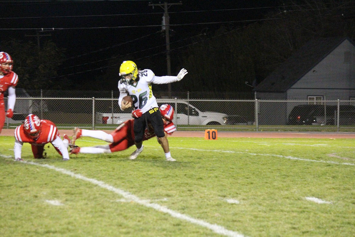 The Othello defense traps Shadle Park’s Beckett Ensminger in the backfield during Friday’s game.