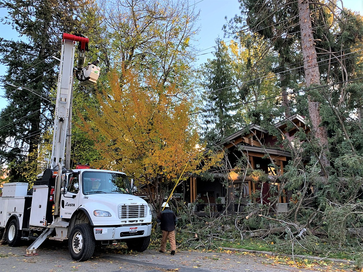 Avista crews work to repair downed powerlines in the Sanders Beach area on Saturday morning.