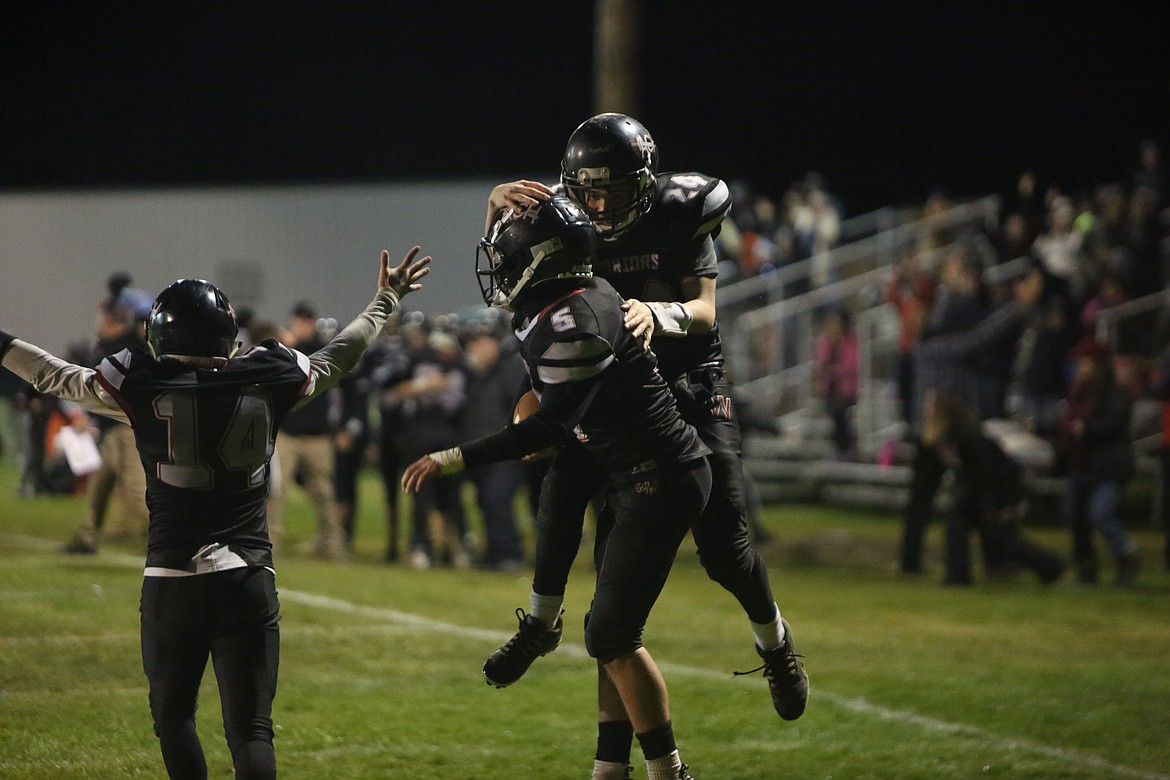 ACH’s Grayson Beal (5), Caden Correia (24) and Tristen Wood (14) celebrate after Beal’s touchdown in the fourth quarter.