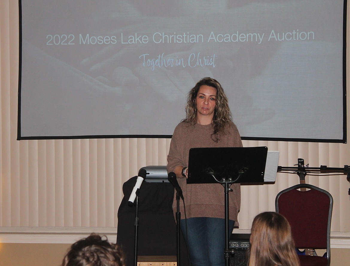 Simone Hampton fights back tears as she speaks about what Moses Lake Christian Academy has meant to her and her family at the school’s fundraiser dinner Saturday.