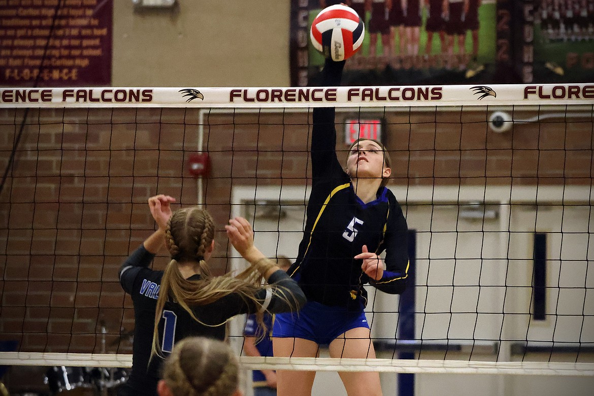 Natalie Roberts rises above the net for a kill against Bigfork in the Western B Divisional Tournament in Florence Friday. (Jeremy Weber/Bigfork Eagle)