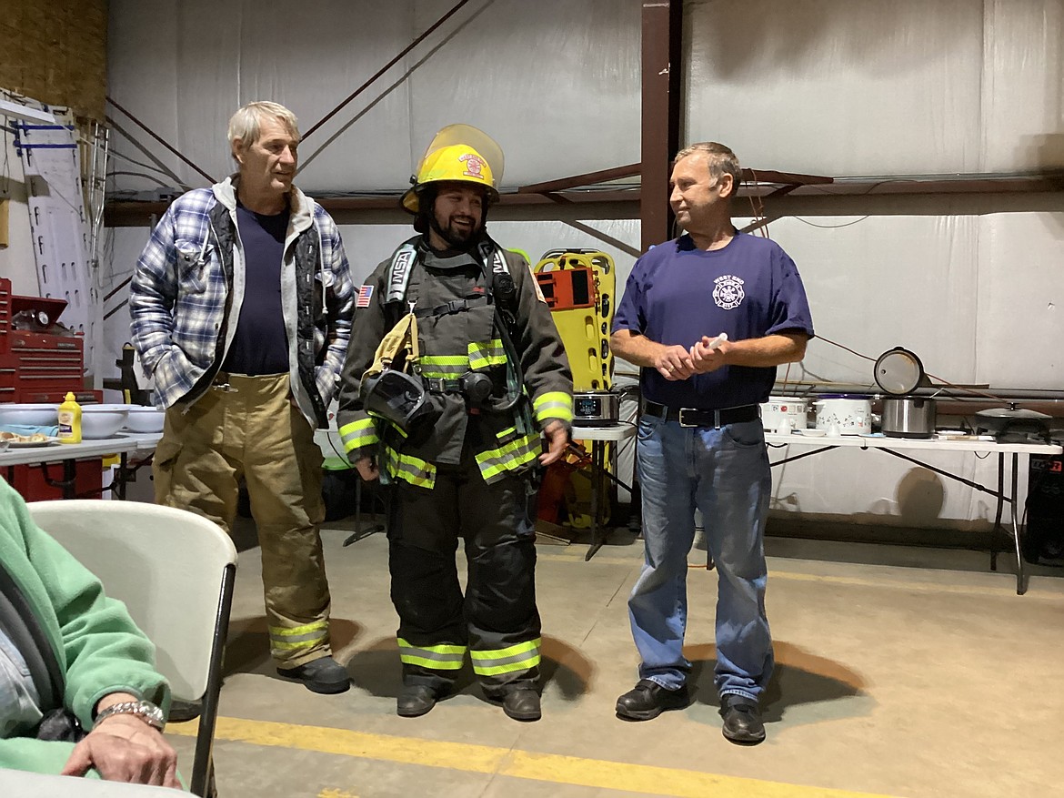 From left, Jerry Doctor, St. Regis Volunteer Fire Department Chief; Shibu Arens, Sen. Tester’s Regional Director; and Frank Magee, West End Volunteer Fire Department Chief made the announcement of a grant for new firefighting gear both departments will share. Arens modeled what they will be receiving with the grant that Tester helped secure. Saturday evening continued with the First Annual Chili Cookoff having nine entries that had five judges sampling and deciding on who should take first place. That went to Susan Charles, with Louise Magee taking second, and third going to Donna Richter. Over 50 people braved a cold, snowy and windy evening to enjoy burgers, hot dogs, chili and celebrate the new equipment. (Photo by Bruce Charles)