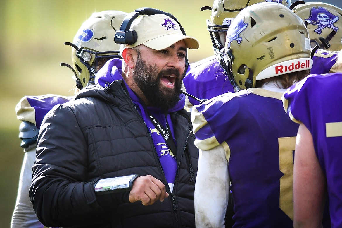 Polson head coach Kaden Glinsmann talks to quarterback Jarrett Wilson (8) and the Pirates offense late in the fourth quarter against Laurel at Polson High School on Saturday, Nov. 5. (Casey Kreider/Daily Inter Lake)