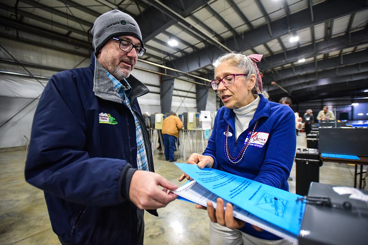 Joel Bowers casts his ballot with Flathead County election judge Clarice Tuttle at the Trade Center at the Flathead County Fairgrounds on Tuesday, Nov. 8. (Casey Kreider/Daily Inter Lake)