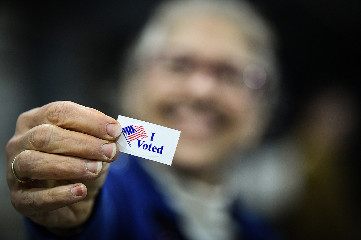 Clarice Tuttle, an election judge with Flathead County, holds an "I Voted" sticker at the Trade Center at the Flathead County Fairgrounds on Tuesday, Nov. 8. (Casey Kreider/Daily Inter Lake)