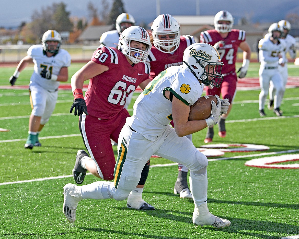 Whitefish's Ty Schwaiger runs the ball down the sideline in the Class A state quarterfinal game against Hamilton on Saturday in Hamilton. (Whitney England/Whitefish Pilot)