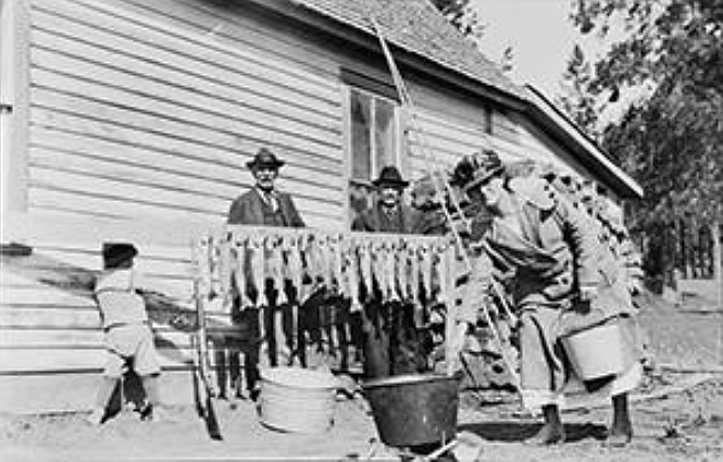 The Weed family, next to their "Fisherman's Home Cafe, displays a day's catch of large trout to be cooked and served for their customers. (Courtesy of the Jeff Wade Family)