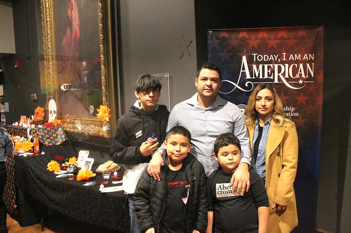 Newly-minted U.S. citizen Jose Mendez of Mattawa stands with his wife Evelia and sons (from left) Ethan, Javier and Ronaldo after his naturalization ceremony Tuesday at the Wenatchee Valley Museum & Cultural Center.