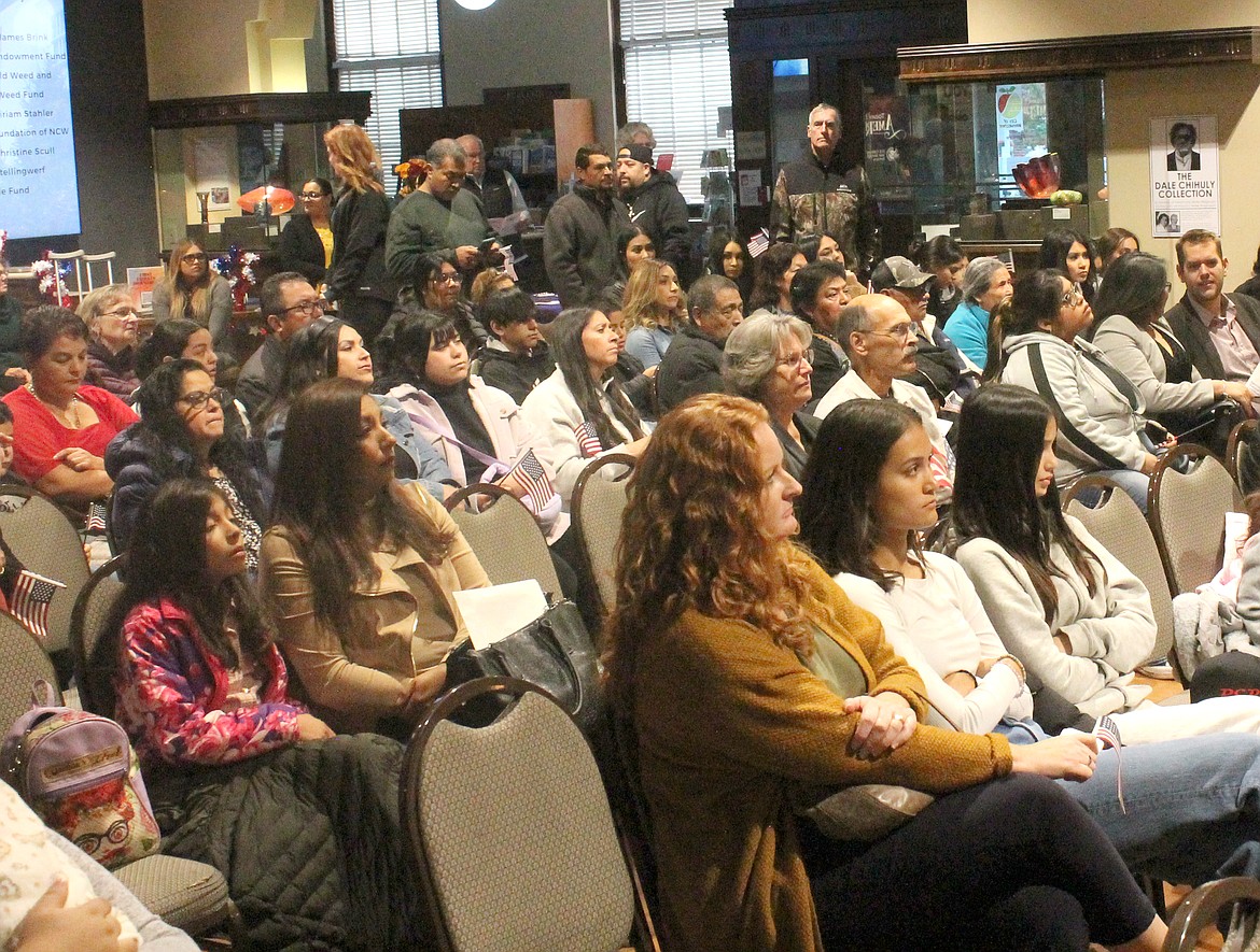 Family and friends were on hand at the Wenatchee Valley Museum & Cultural Center Tuesday to welcome 25 new U.S. citizens.