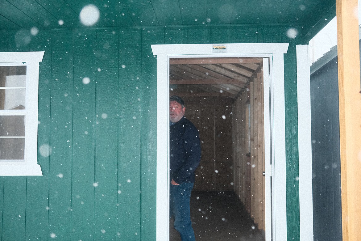 Gordon Lister of Gordy's Old Hickory Sheds steps in to a shed on his sales lot in Evergreen. (Adrian Knowler/Daily Inter Lake)