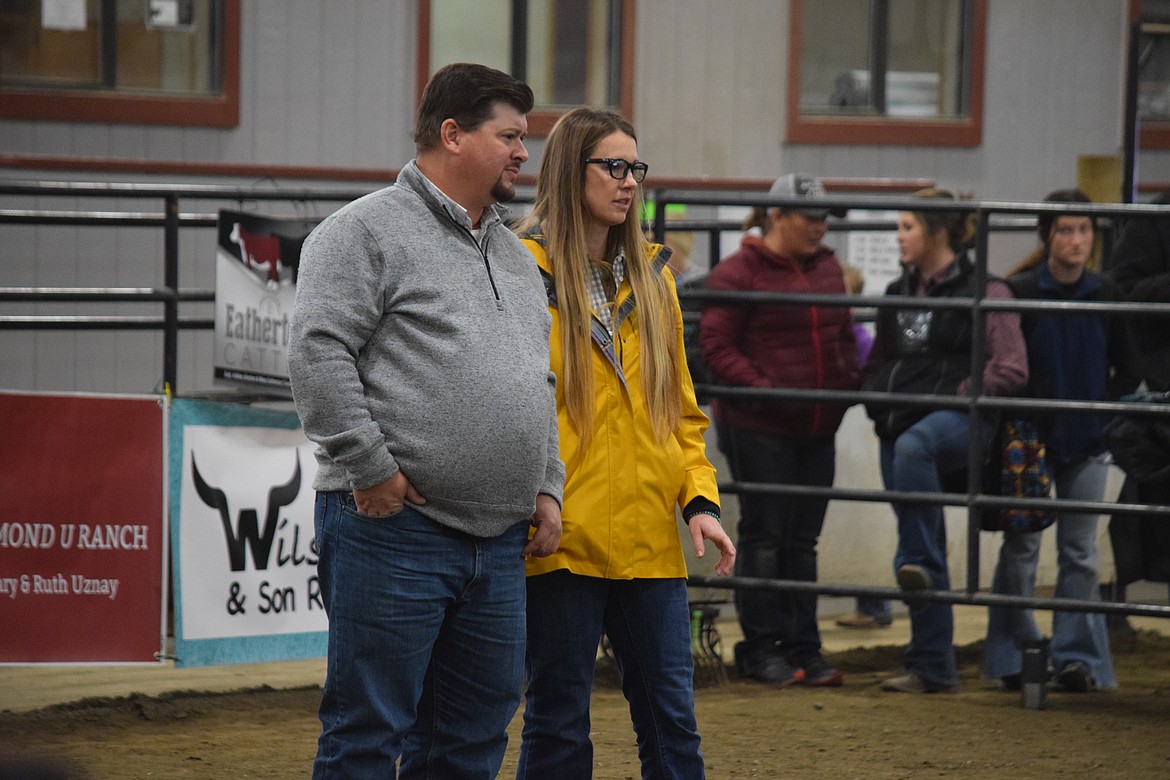 Western Showcase Jackpot judges Skyler and Taylor Jarman, both of Ellensburg, stand and in the ring and examine contestants’ steers during the competition on Saturday. The two filled in for the original judge, who got stuck in Dallas on the way to Moses Lake, according to Moses Lake rancher and show volunteer Floyd Lewis.