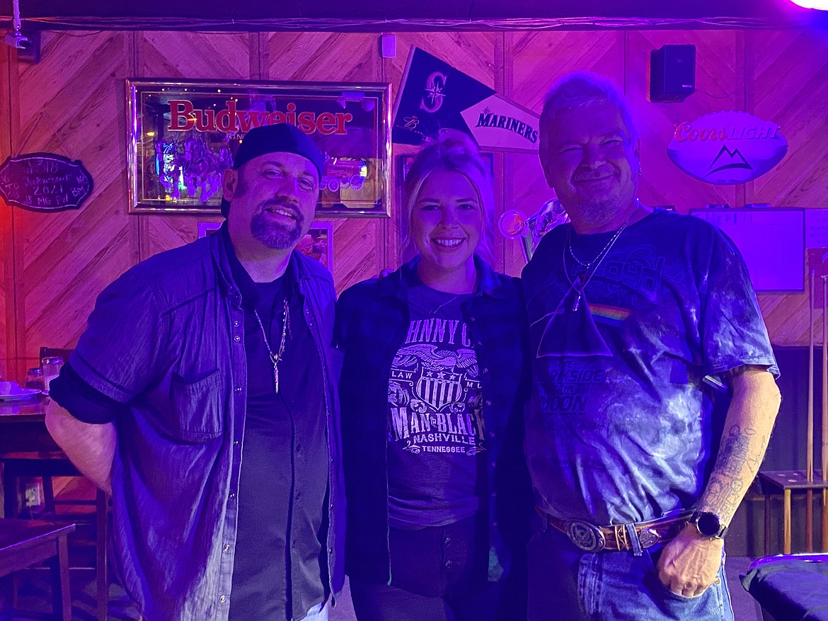 Jake Daniels, left, and Dan Ellison, right, performed at the Soap Lake Del Red Pub Friday night where attendee Melissa Baker, center, was the focus of a few of Daniels’ magic tricks.