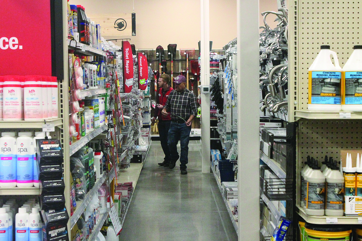 Manager McLain Fanning (left) helps a customer in the plumbing section of Ace Hardware.