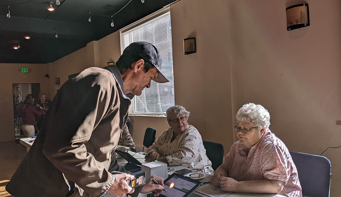 Voter Paul Roberts signs himself in to cast his vote on Tuesday afternoon at the Kellogg Elks.