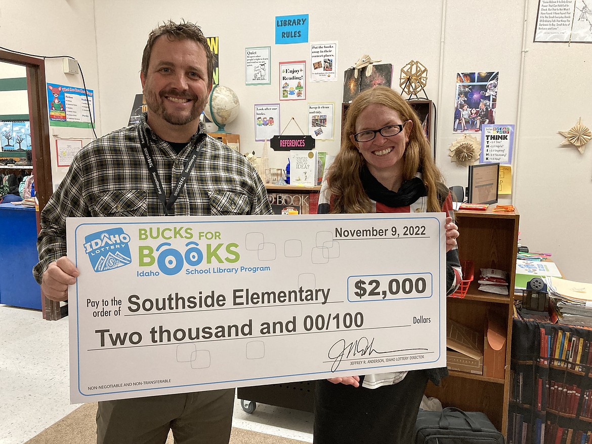 T.J. Clary, Southside principal, and Lynette Leonard, Southside Elementary librarian, accept an award from Idaho Lottery to buy books for the school's library.