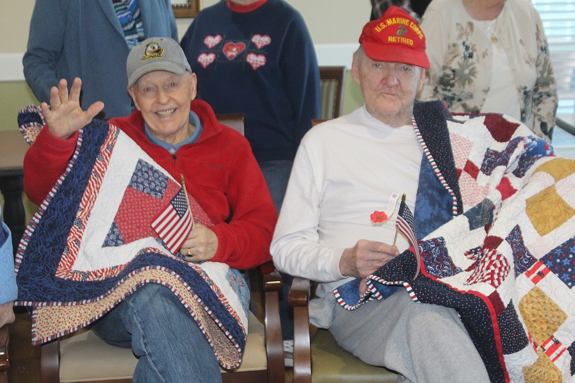 Brookdale Hearthstone veterans show off their new quilts after a presentation from the Baskin Piecemakers Guild Nov. 9.