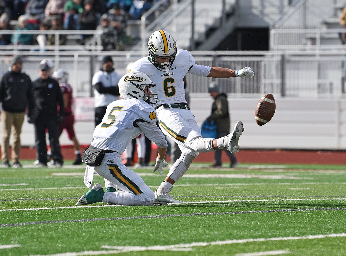 Bulldog Ryder Barinowski kicks a PAT during a quarterfinal playoff game against Hamilton Saturday. (Whitney England/Whitefish Pilot)