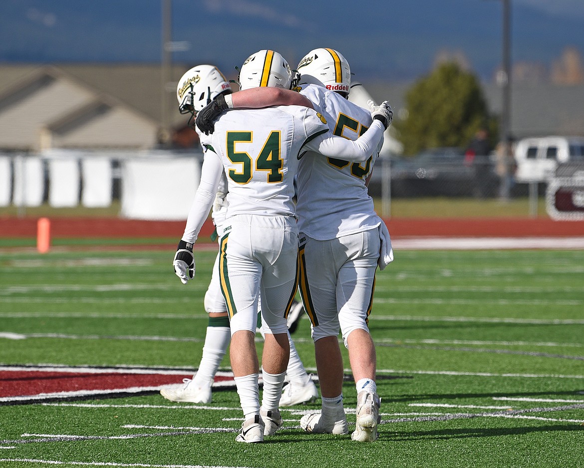 Whitefish football players support each other after falling to Hamilton in a quarterfinal playoff game on Saturday. (Whitney England/Whitefish Pilot)