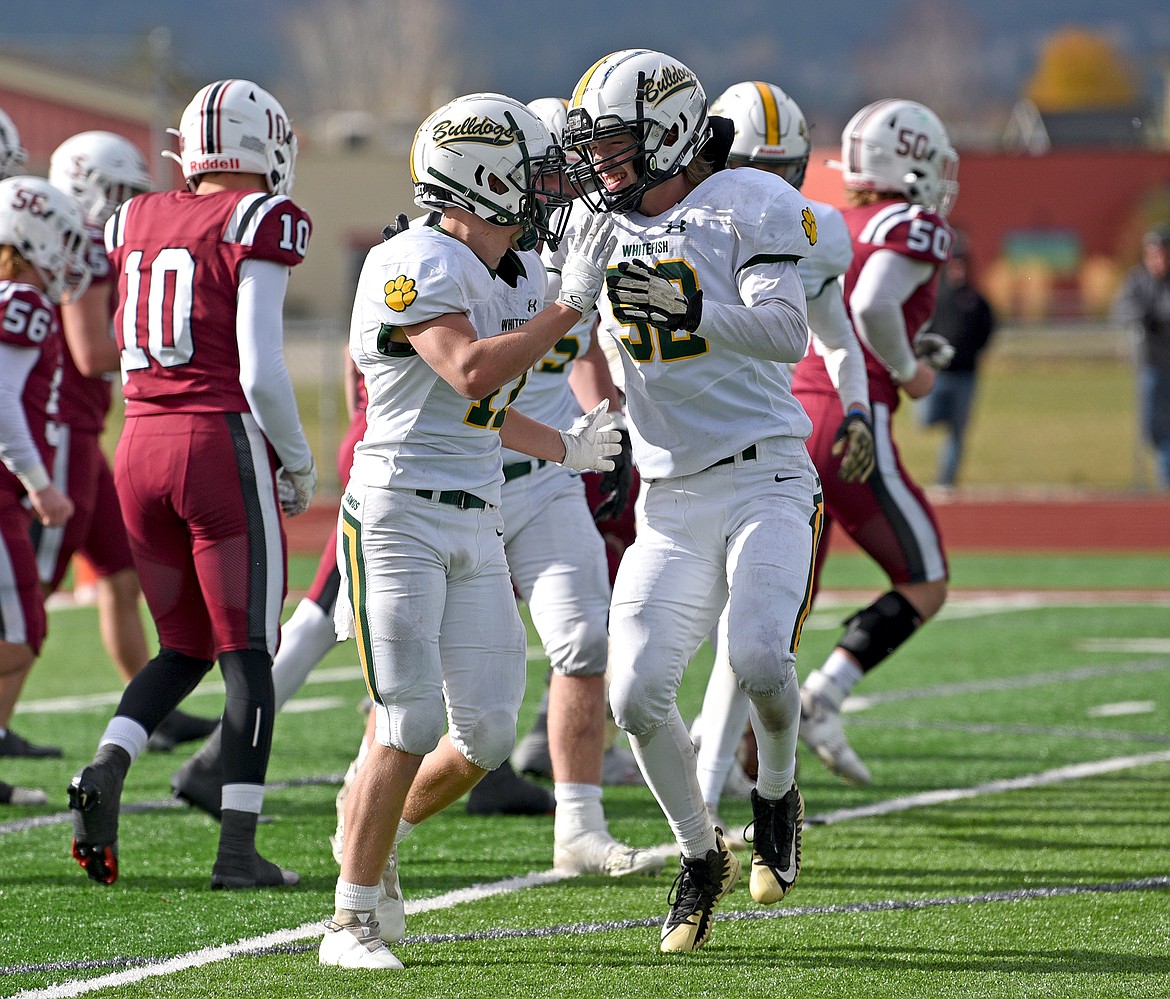 Bulldogs celebrate making a big play during a quarterfinal playoff game against Hamilton Saturday. (Whitney England/Whitefish Pilot)