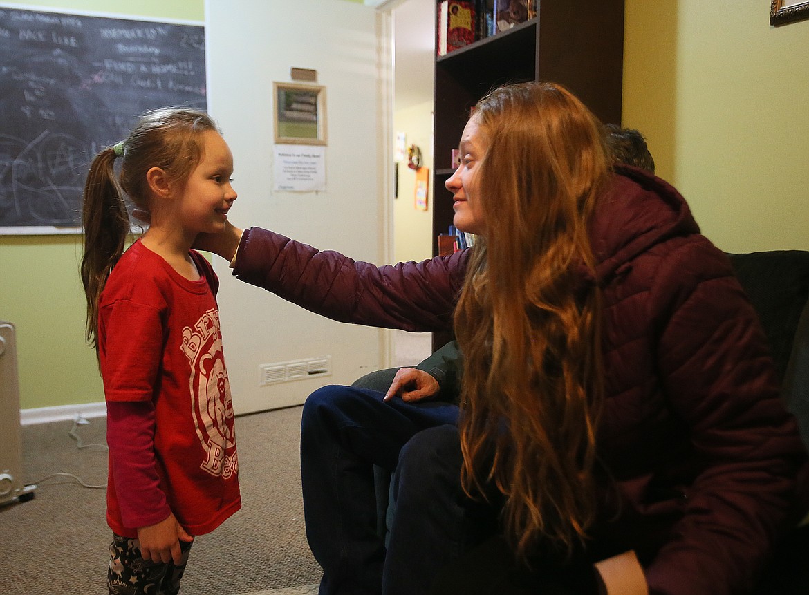 Mom Brooke Carroll shares a loving moment with her 5-year-old daughter Abigail in the Family Promise of North Idaho office Thursday.