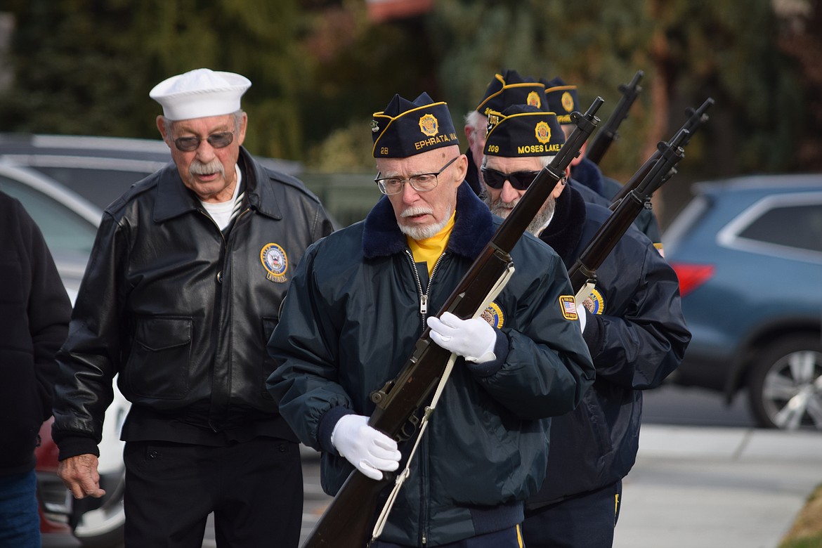Members of the American Legion Post 28 honor guard march up to the Grant County Courthouse’s Vietnam War Memorial at the end of the annual Veterans Day Parade in Ephrata on Friday.
