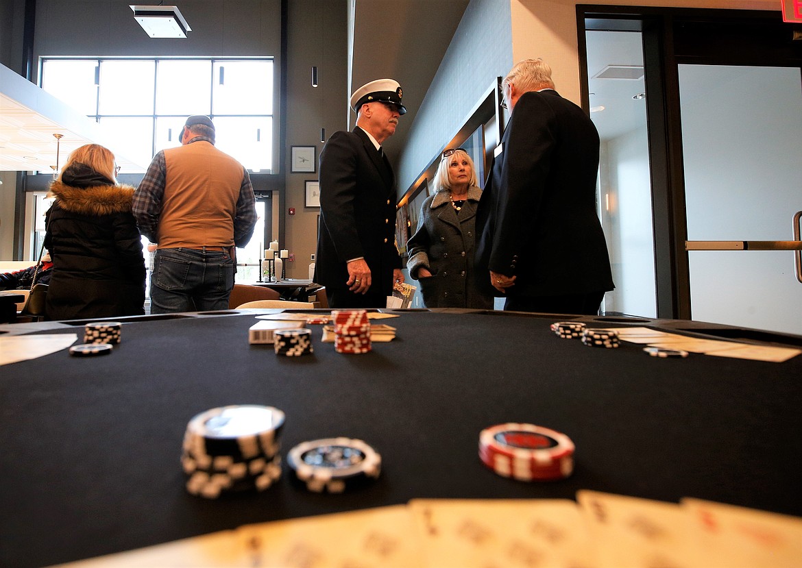 Cards and chips wait for action on the table in the game room at the Veterans Home in Post Falls on Friday, while guests chat nearby.