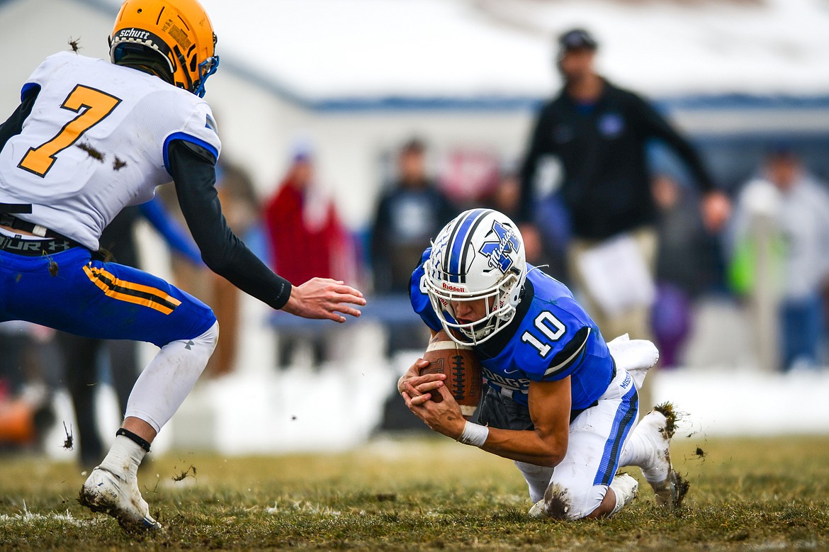 Mission defensive back Kellen McClure (10) recovers a fumble by Fairview quarterback Jeff Tjelde (7) in the first quarter at St. Ignatius High School on Saturday, Nov. 12. (Casey Kreider/Daily Inter Lake)