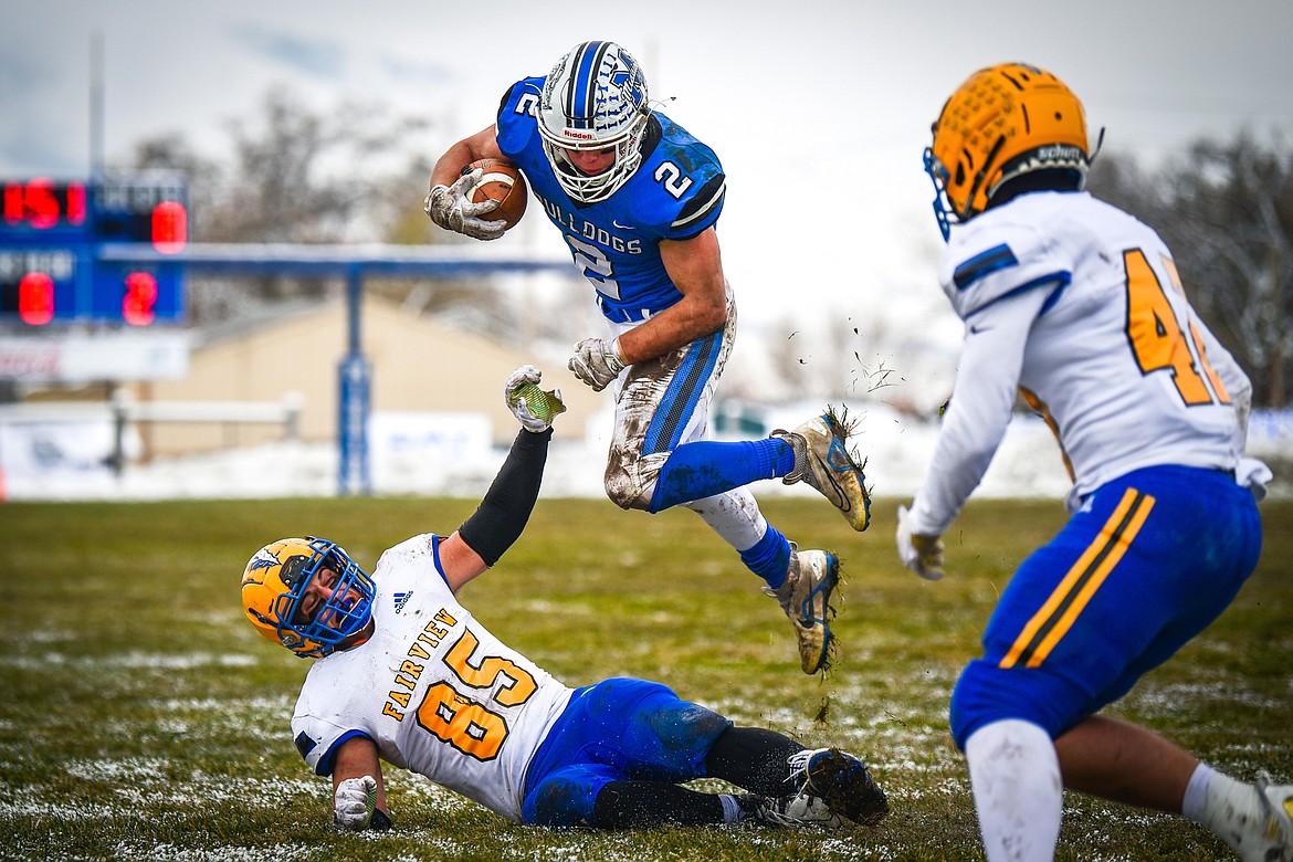 Mission running back Canyon Sargent (2) is tripped up by Fairview linebacker Hunter Sharbono (85) as he goes airborne on a run in the second quarter at St. Ignatius High School on Saturday, Nov. 12. (Casey Kreider/Daily Inter Lake)