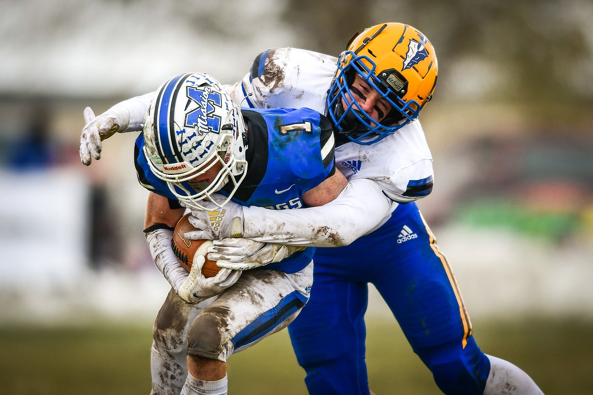 Mission wide receiver Bryce Umphrey (1) is brought down by Fairview linebacker Deacon Gackle (42) in the third quarter against Fairview at St. Ignatius High School on Saturday, Nov. 12. (Casey Kreider/Daily Inter Lake)