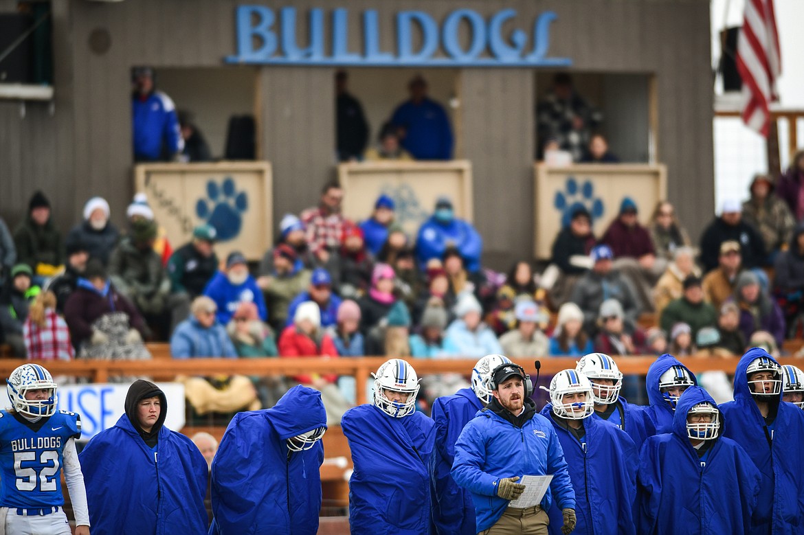 Misson players keep warm on the sidelines in the first quarter against Fairview at St. Ignatius High School on Saturday, Nov. 12. (Casey Kreider/Daily Inter Lake)