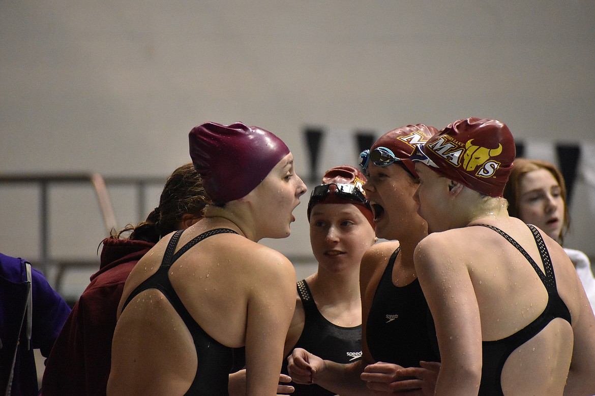 Members of the Moses Lake High School Swim team show shock and excitement when they found out they took fourth place as a team at the state competition, a goal they had since the beginning of the season.