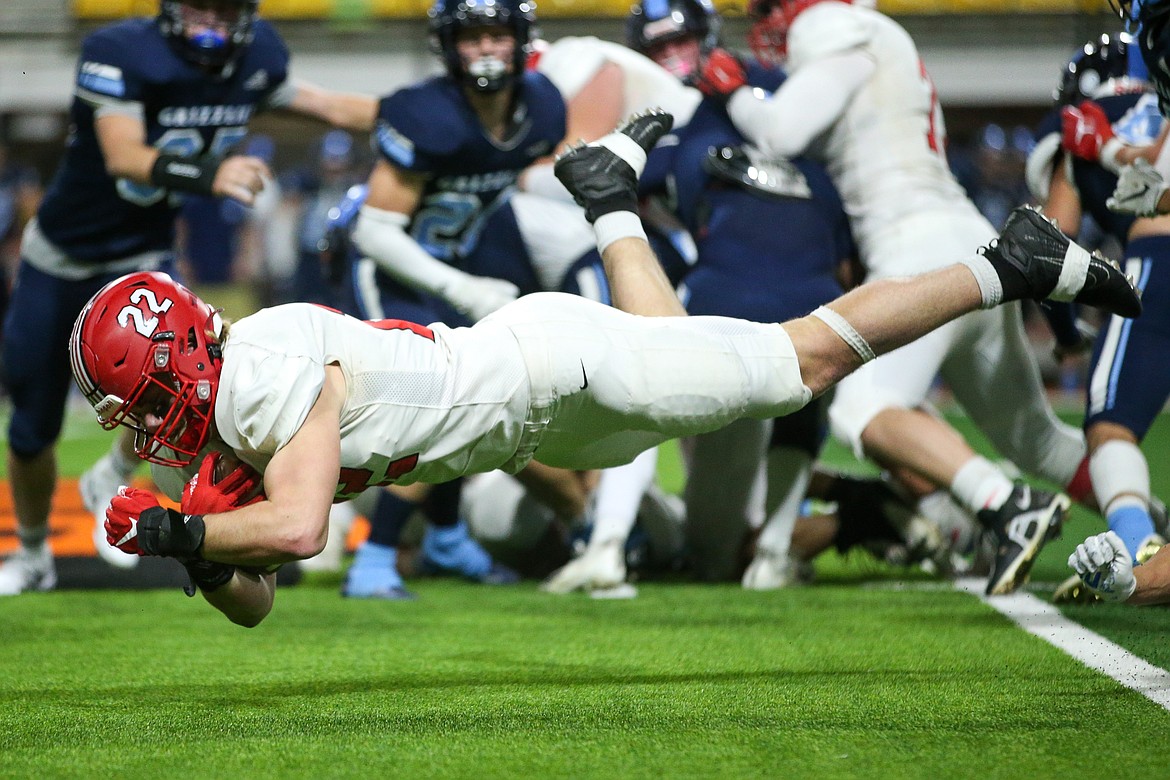 Wes benefield dives for a first down in the state 4A high school football semifinals at Holt Arena in Pocatello.