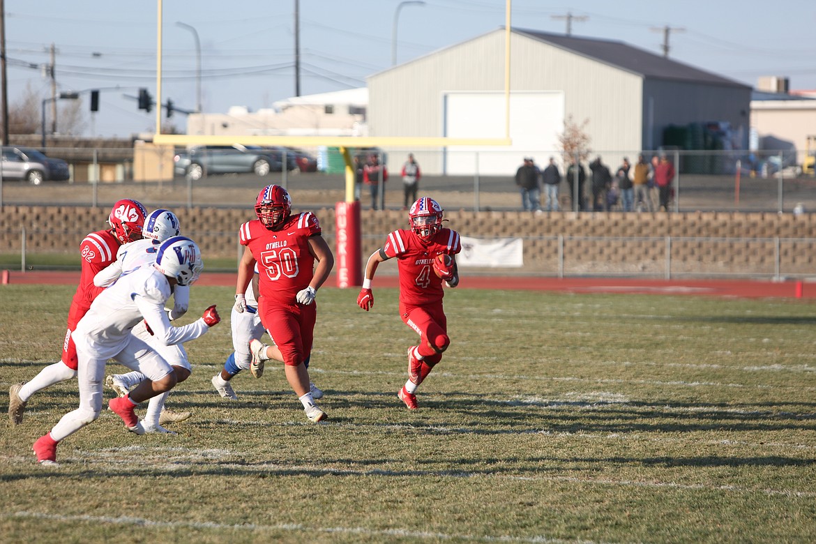 Othello senior Sonny Asu (4) follows blockers on a run in the third quarter.