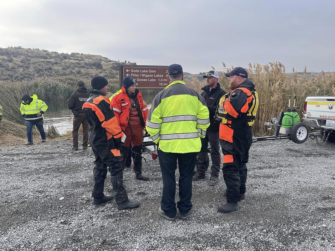 Several agencies have been involved in the response and recovery effort after a father and his three children went into a lake in the Columbia National Wildlife Refuge after their canoe capsized Friday. Divers and other responders discussed strategy and tactics Sunday during their search for the father and son who were still missing.