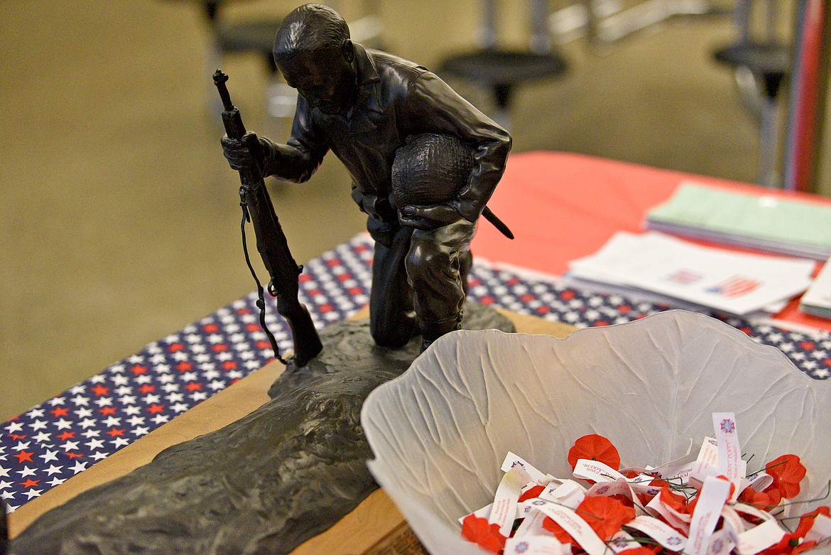 A bowl of red poppies on the welcome table at Whitefish High School Veterans Day Celebration event on Thursday, Nov. 10. (Whitney England/Whitefish Pilot)