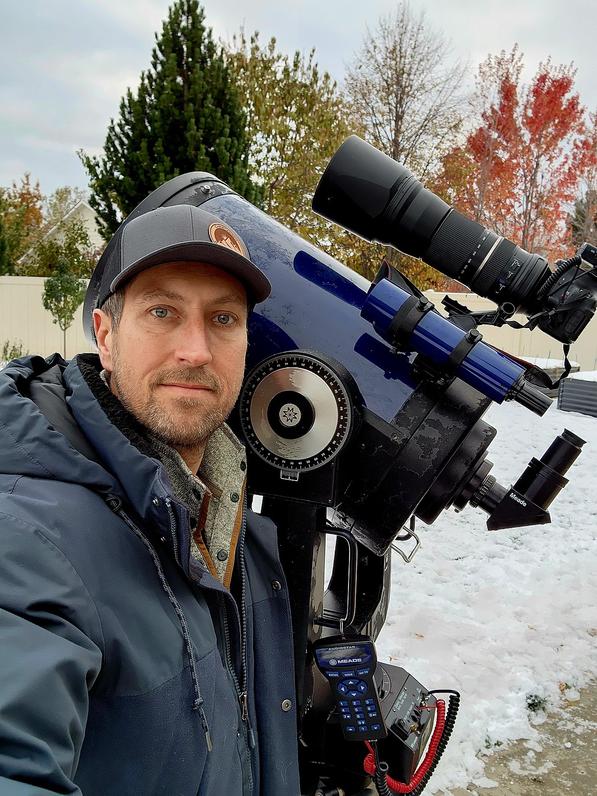 Mike Christiansen poses with his telescope, a 12" Meade-Schmidt Cassegrain he uses to introduce people to the planets. The telescope is powerful enough to see the rings of Saturn and craters of the moon on a clear night.